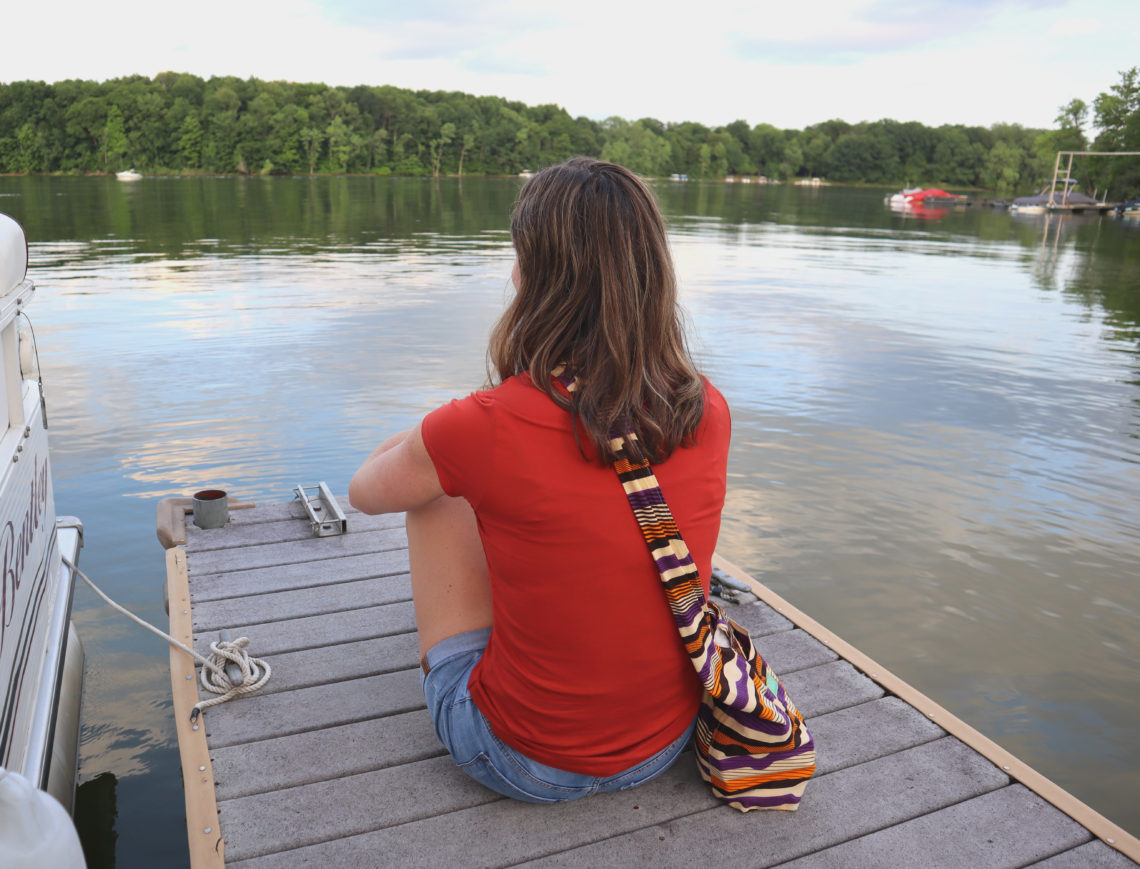 woman sitting on dock